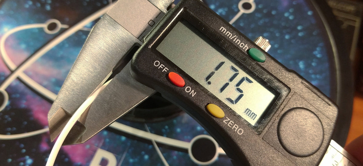 Digital calipers measuring the diameter of filament as 1.75mm