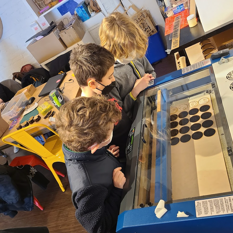 Kids looking at Laser Cutter
