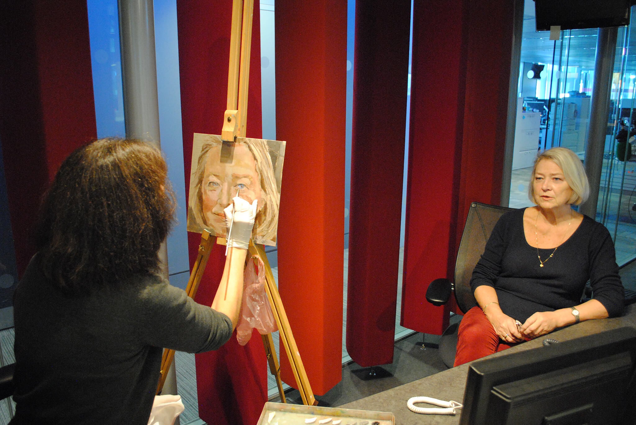 Stella Tooth painting a portrait in oils of Kate Adie in BBC Broadcasting House radio studio.