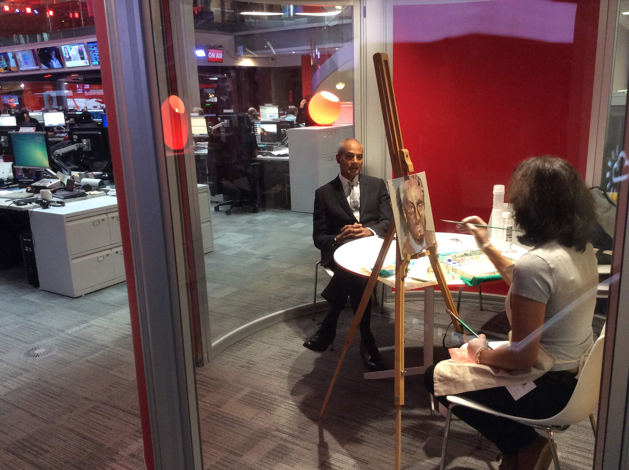 Stella Tooth painting a study of George Alagiah in oils in the BBC Newsroom.