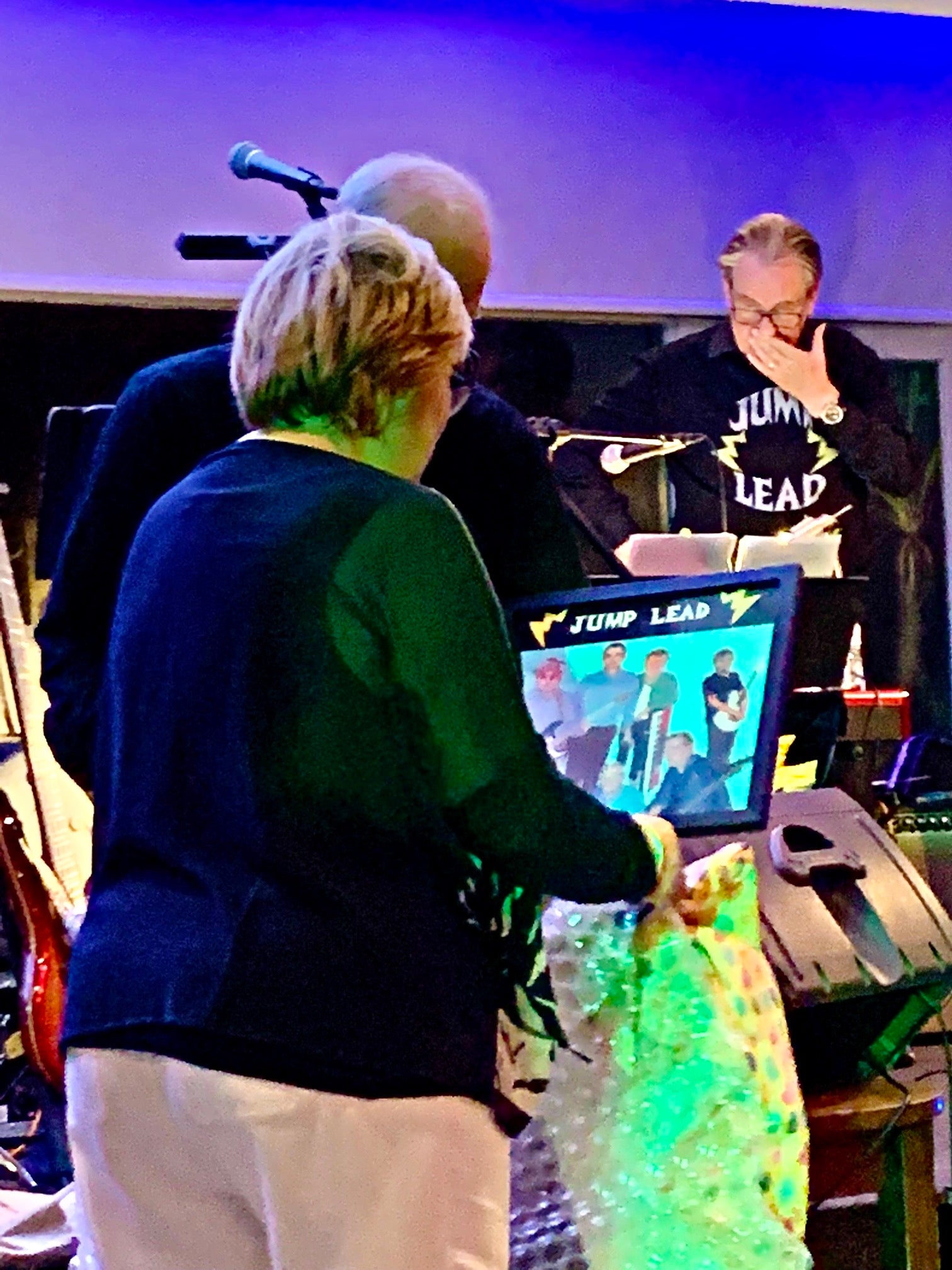 Jump Lead's final gig Judi being presented with Jump Lead album cover by Stella Tooth in memory of her husband band member Lyn