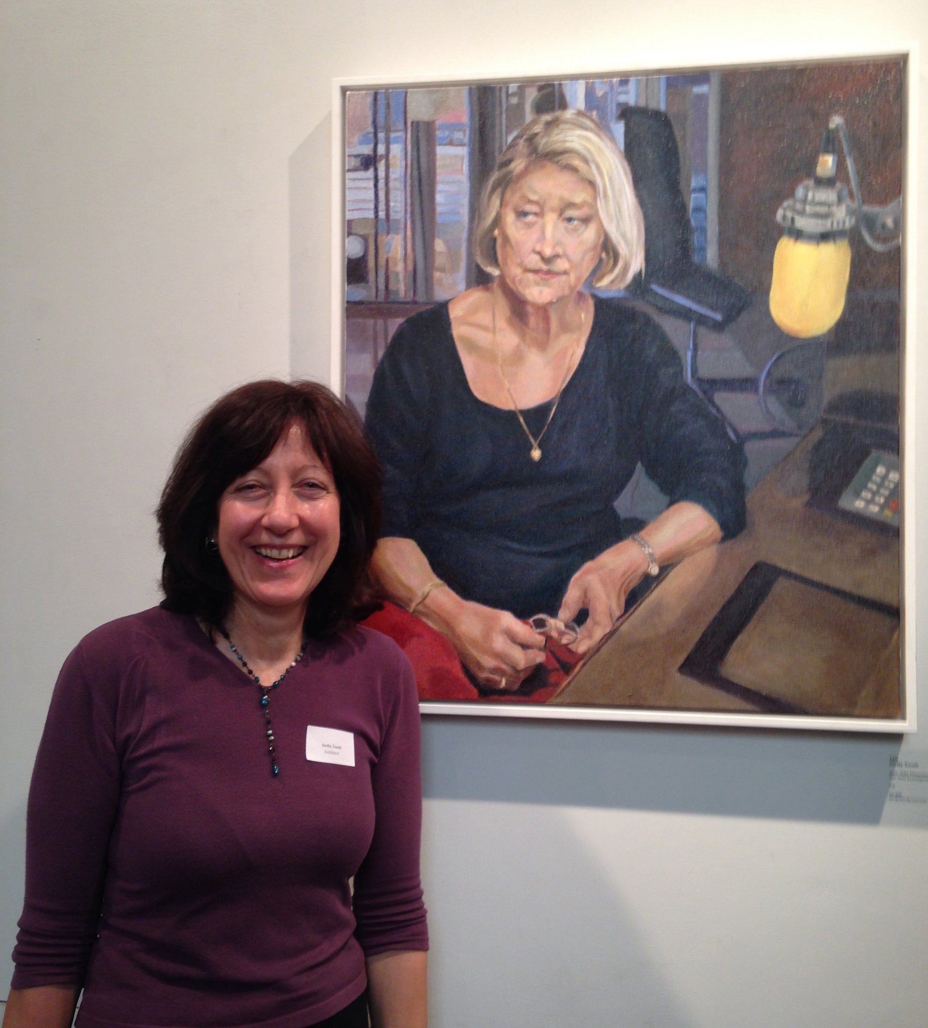 Artist Stella Tooth with her oil portrait on canvas artwork of BBC's Kate Adie at Royal Society of Portrait Painters Annual Exhibition 2015.