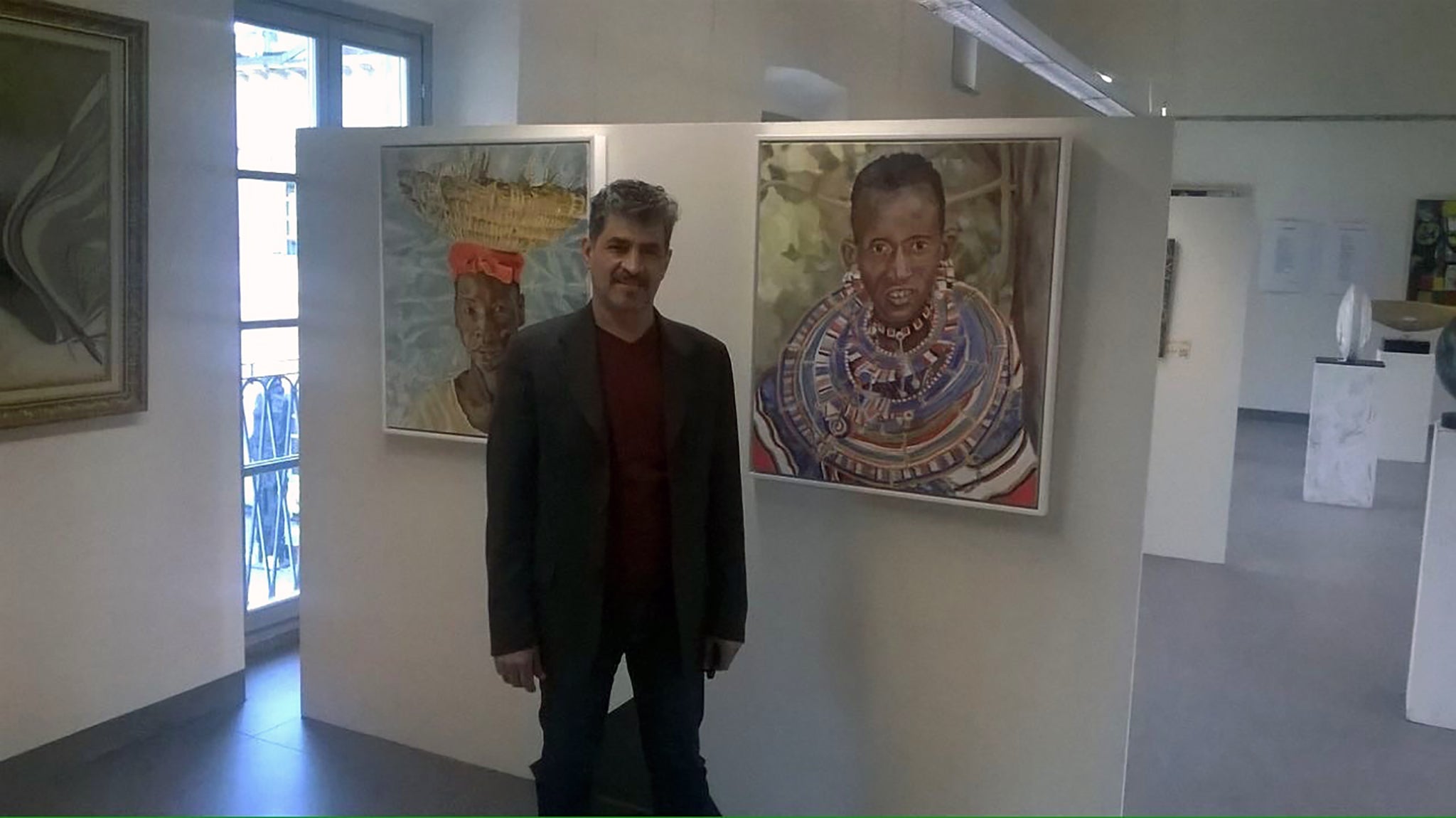 Organiser Gamal Meleka with Stella Tooth's portraits at the Milan Expo 2015.