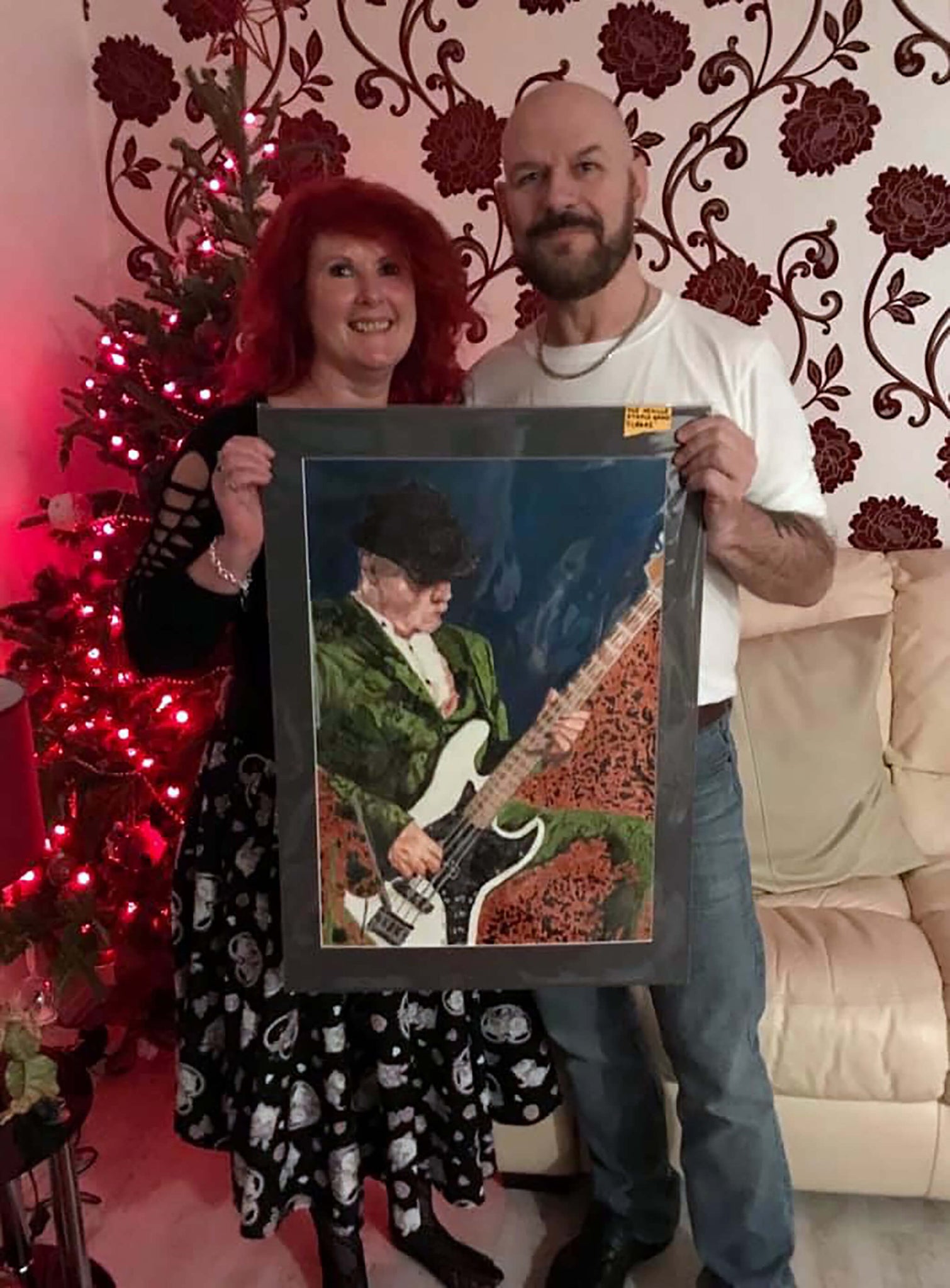 Neville Staple Band's Sledge and wife with Stella Tooth's portrait of him in action, her Christmas gift to him.