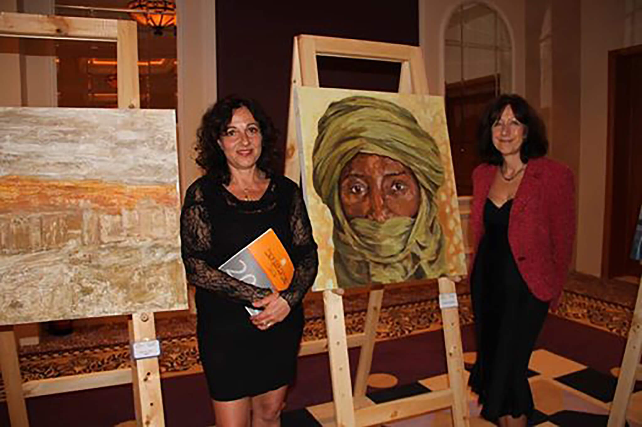 Artist Stella Tooth with her Saharan Tuareg portrait at Egypt's first art biennale in Sharm El Sheikh.