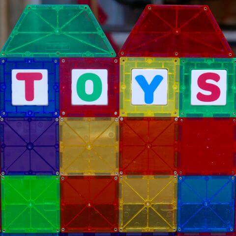 Magnetic tiles building with the word toys on them