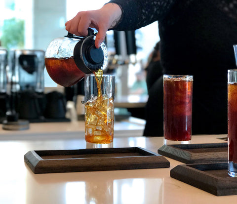 Pouring cold brew into glass at Parisi