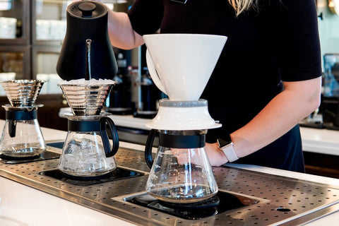 Barista pouring iced coffee at Parisi