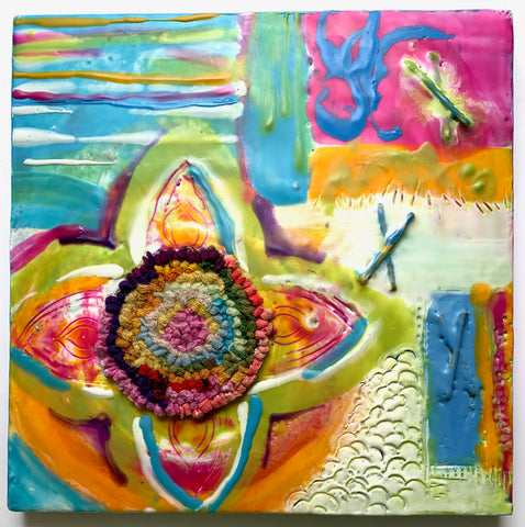 This is a square painting. In the lower left quadrant there is a  four petaled flower of green, pink, white and yellow surrounding a rug hooked circle at centre. Yellow circular brushstroke are around the base of the lower two petals. A striped rectangle with mostly turquoise is top left and a fuchsia and blue rectangle is top right. White with textured scallops and a brushstroke of blue, yellow and red are in the lower right quadrant. Made from encaustic paint, the surface is texture. Two Xs made from sticks emerge from the surface in the top right quadrant.