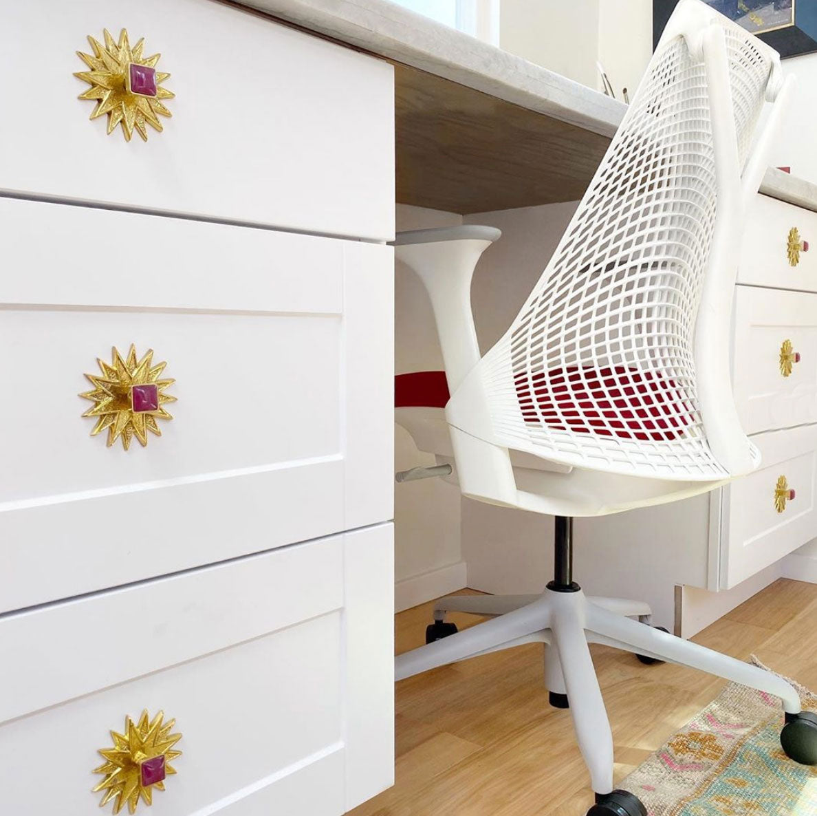 Horne Knob in Pink Jade with Polished Brass Star Backplate on White Desk Drawers