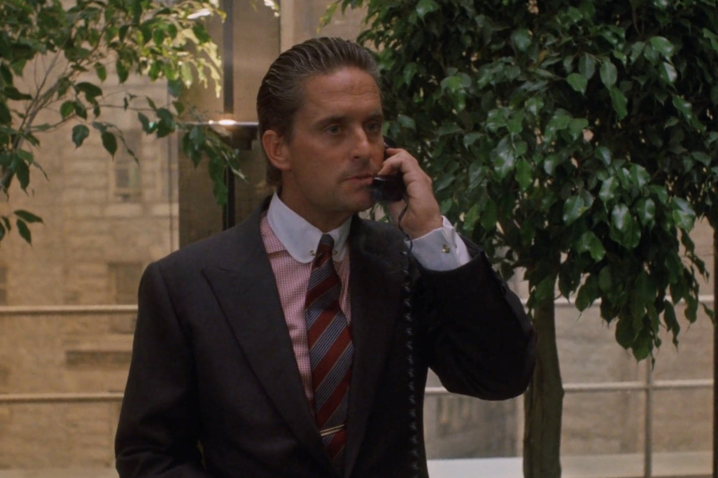 Michael Douglas as Gordon Gekko wearing a club collar winchester shirt in the movie Wall Street