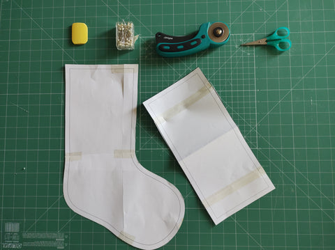 Christmas stocking sewing pattern, scissors, chalk, measuring tool, rotary blade, safety pins