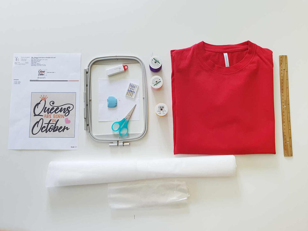 Tshirt embroidery supplies, red cotton t-shirt, machine embroidery fusible stabilizer, ballpoint needle, 5x7 hoop, usb flash drive with embroidery file, printed embroidery documentation for design, wash away stabilizer, ruller and chalk for measurement