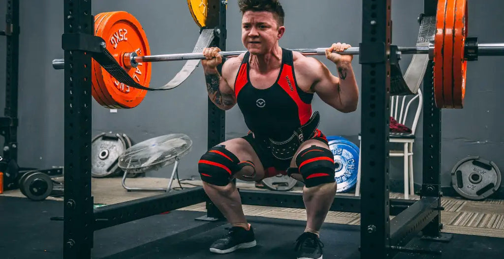 man squatting weight with sore thighs