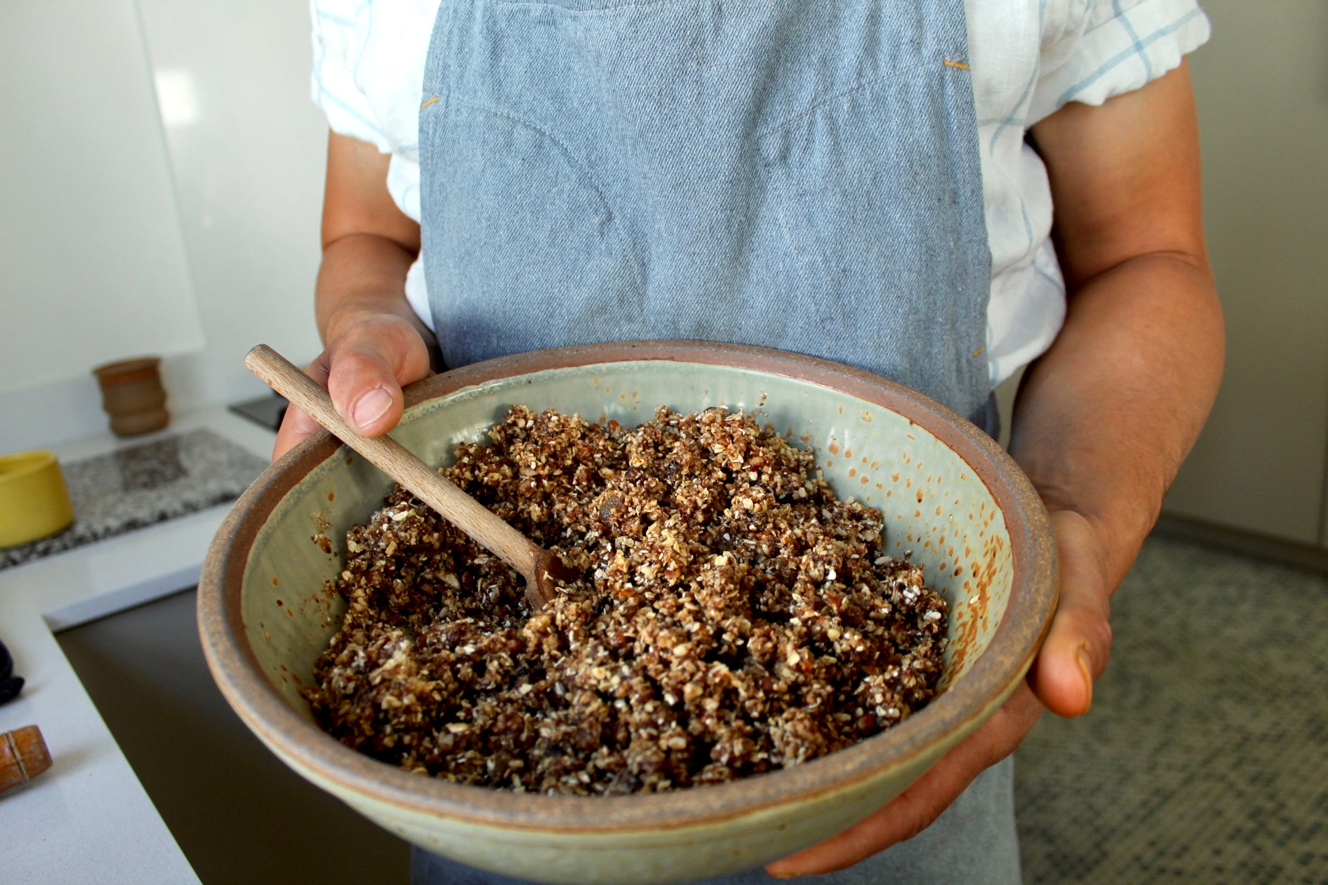 Nana Joes Granola bar recipe - man in an apron holding granola bar mix