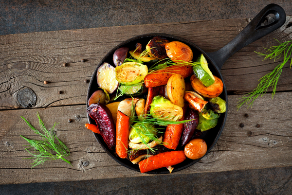 Colorful Vegetables And Herbs Cooked In Cast Iron Skillet