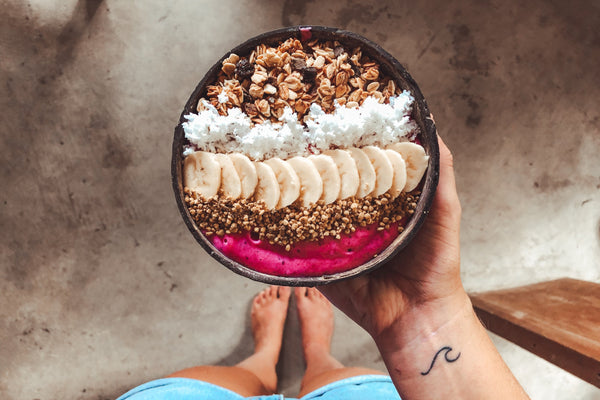Woman With Wave Tattoo On Wrist Holding Smoothie Bowl Made With Pink Pitaya Dragon Berry Powder