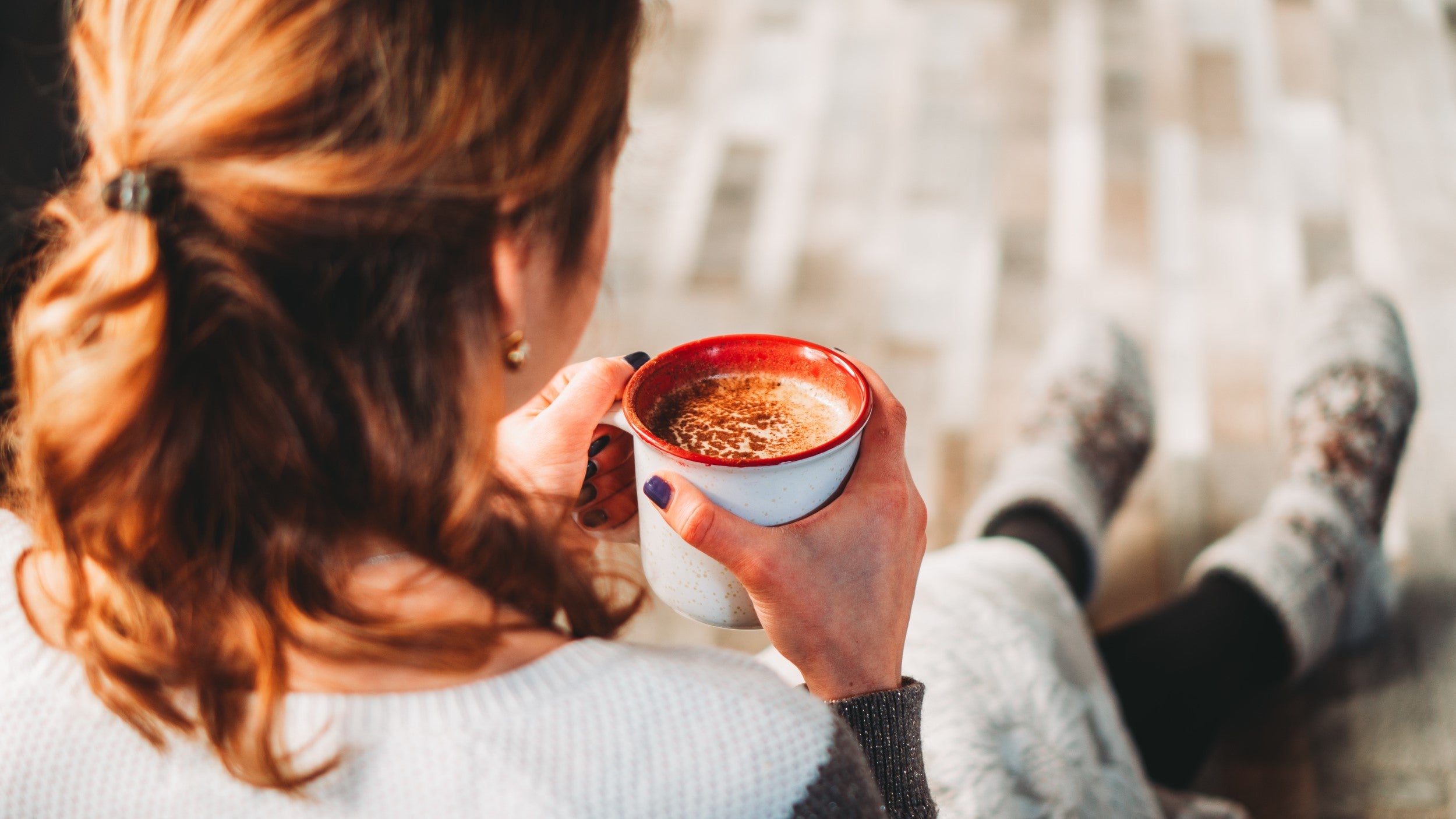 Woman Enjoying Organic Cocoa And Spice Topped Hot Beverage From Terra Powders At Home During Winter