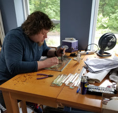 Worker at desk, making piece