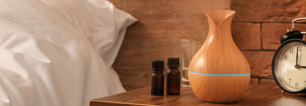 diffuser and essential oils by bed