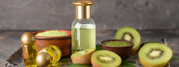 essential oil bottle with sliced kiwis