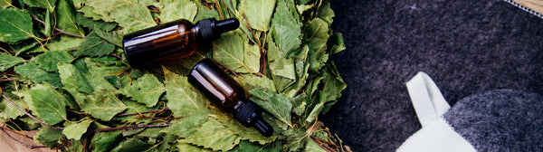 essential oil bottle on birch broom