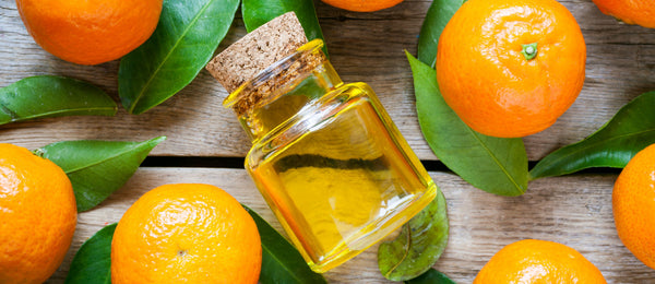 oil in glass bottle with tangerines