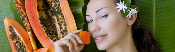 woman applying papaya to face