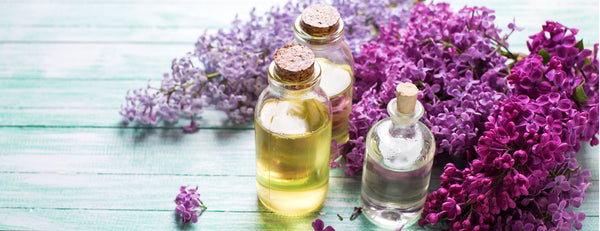 essential oil bottles with lilac flowers