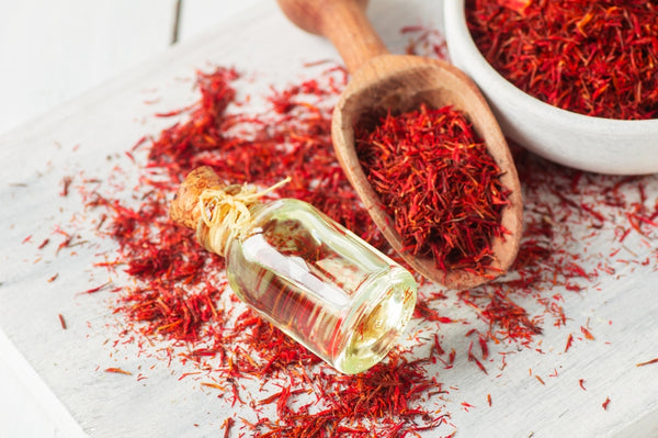 essential oil bottle with saffron bowl and spoon