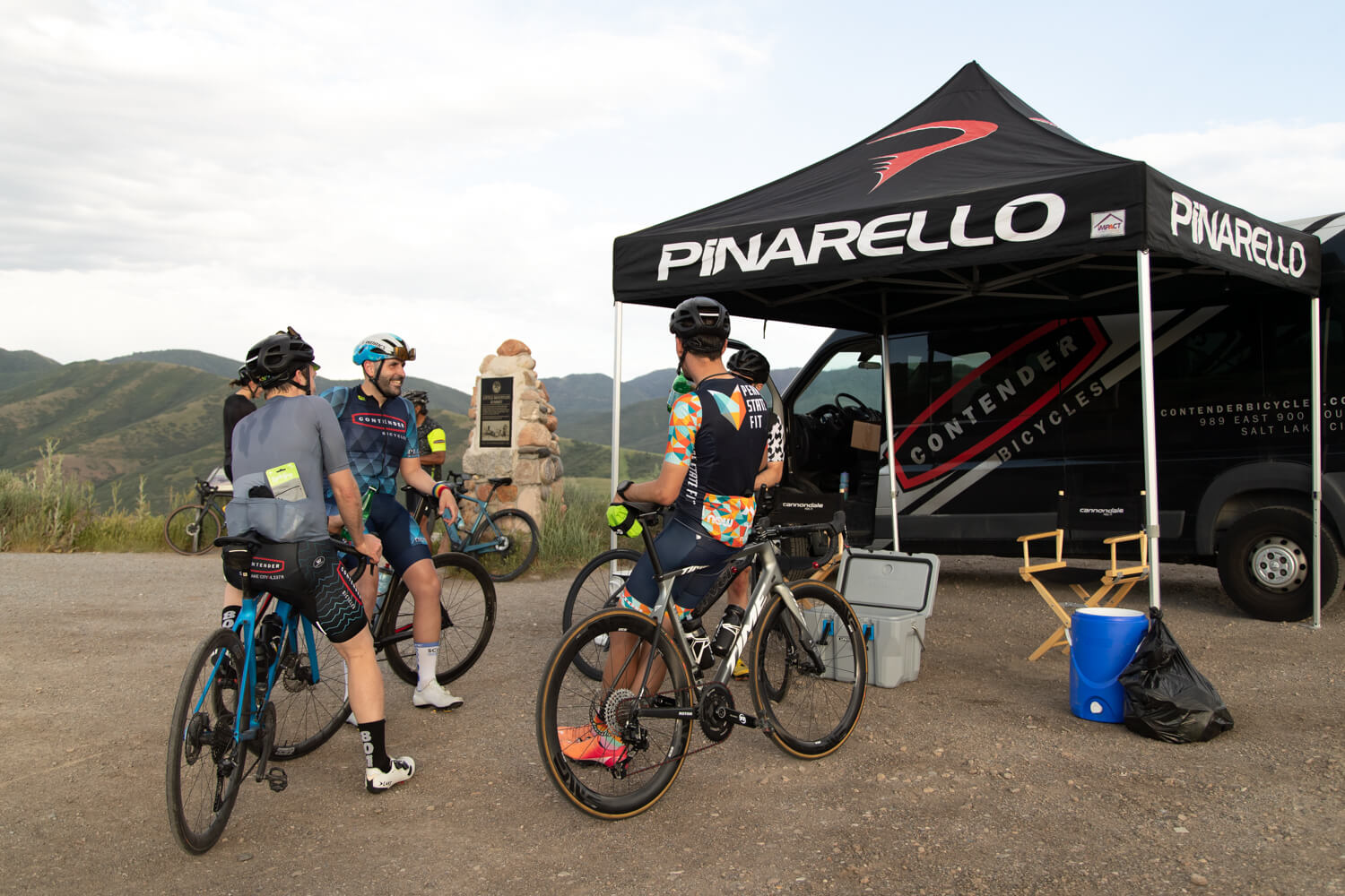 a group of cyclists gathering to get ready for a ride