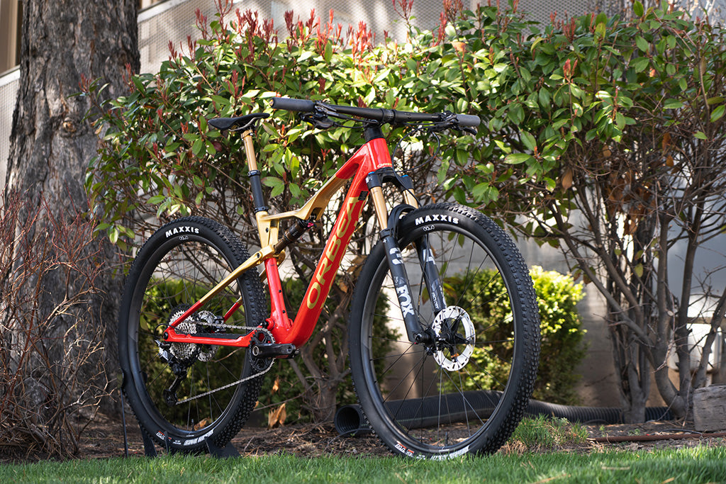 a sharp looking Orbea Oiz M-Pro custom spec'd and colored in red and gold