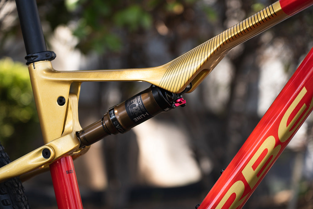 a sharp looking Orbea Oiz M-Pro custom spec'd and colored in red and gold