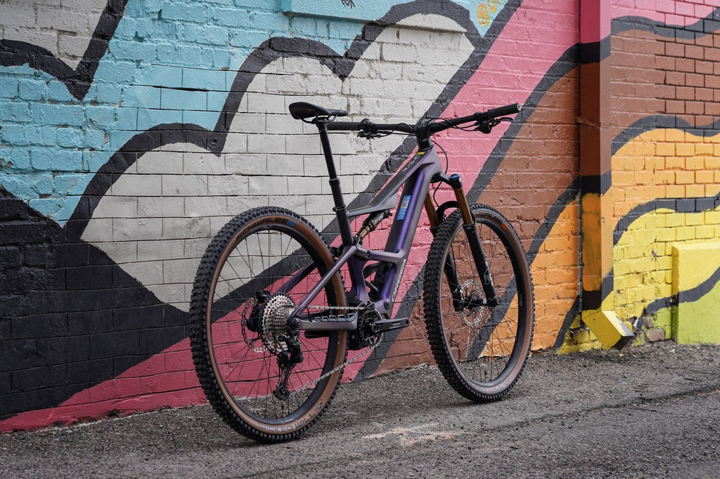 Orbea Rise SL against colorful wall.