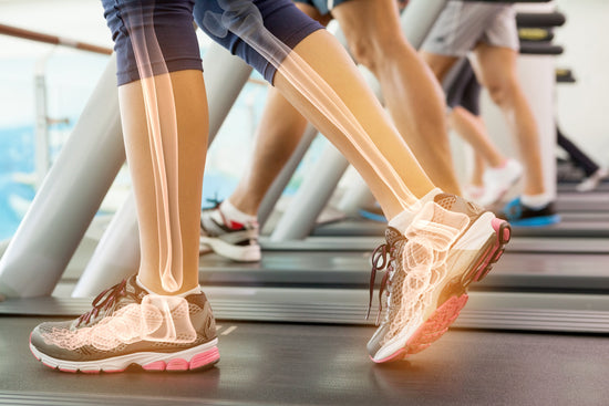 A close-up of a person's lower legs and feet in motion on a treadmill, highlighting the skeletal structure to emphasize the importance of minerals for bone health and strength