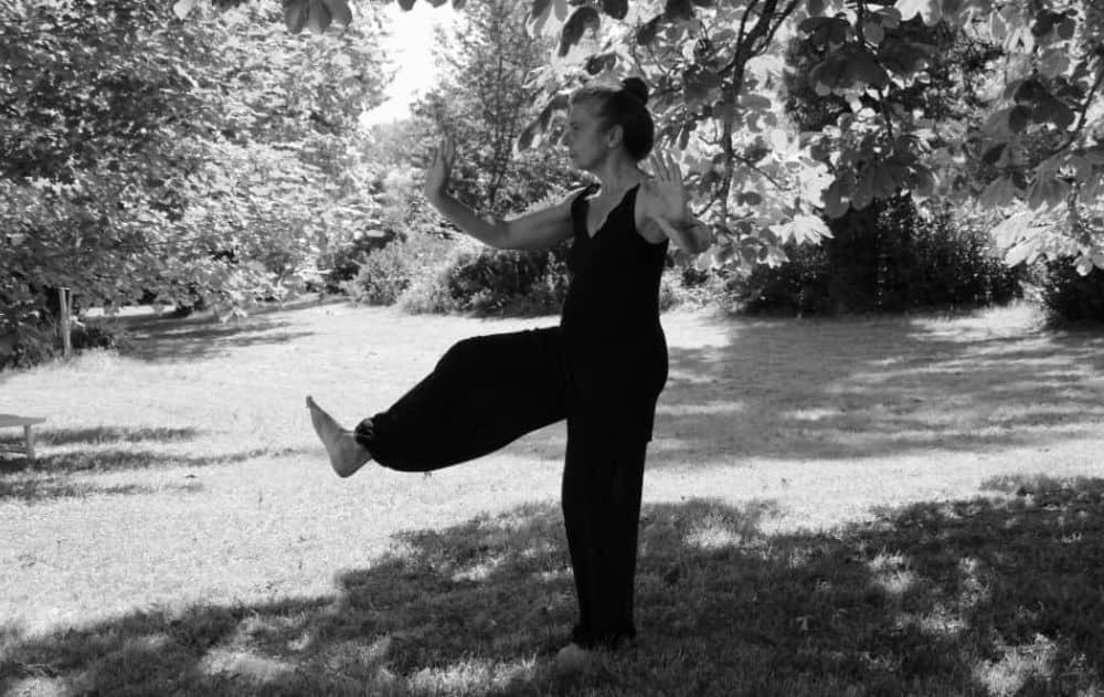woman practicing tai chi outdoors