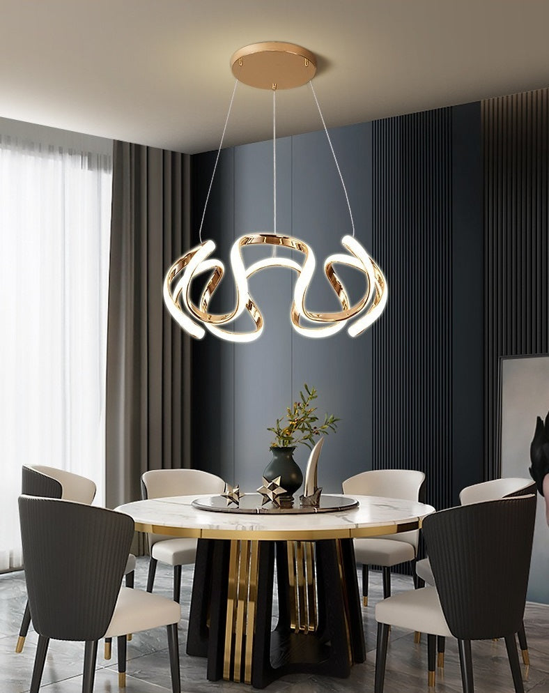 A modern Nordic dining room with a minimalist gold and black dining table and chairs, illuminated by a stunning pendant light.