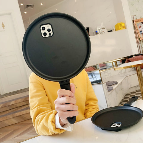 A person showcasing an innovative SmartFun™ iPhone case with a pan design.