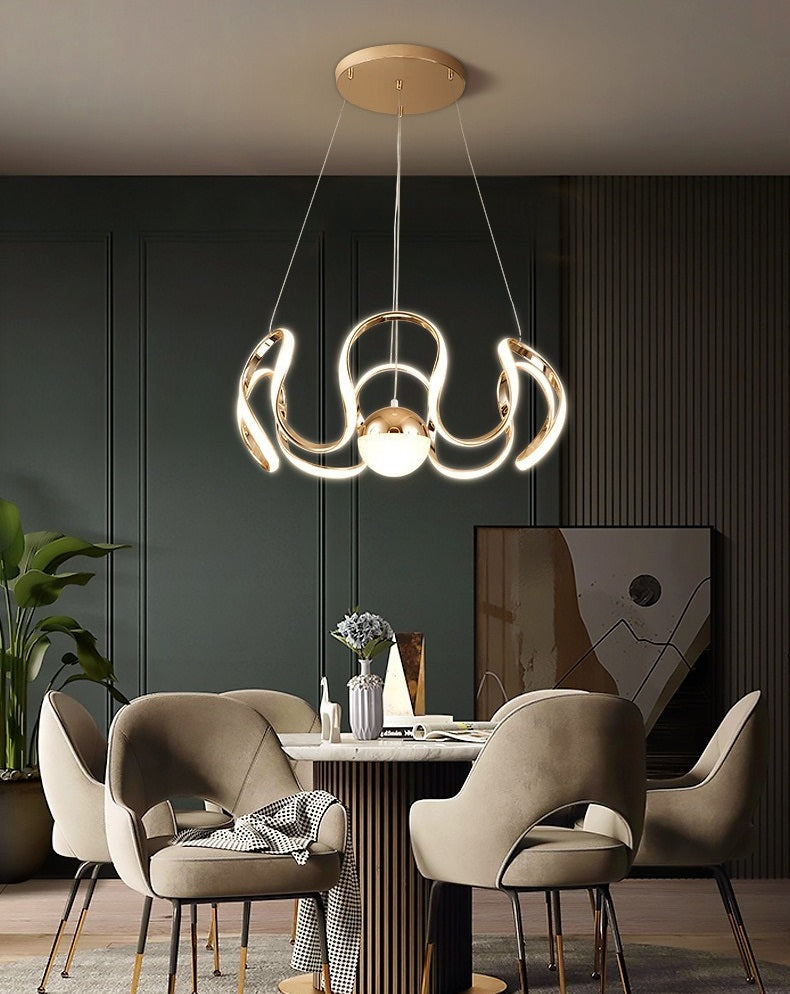 A modern Nordic dining room with a dining table and chairs enhanced by the warm glow of an Ohm pendant light.