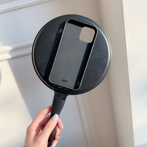 An innovative iPhone case that transforms your phone into a SmartFun™ experience, resembling a person holding a pan.