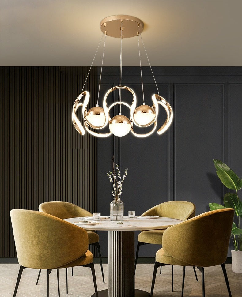 A modern dining room with yellow chairs and a pendant light.