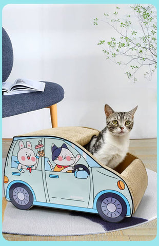 A lovely cat is sitting in a SmartSUV™ Cat Car made out of cardboard, occasionally giving a scratch.