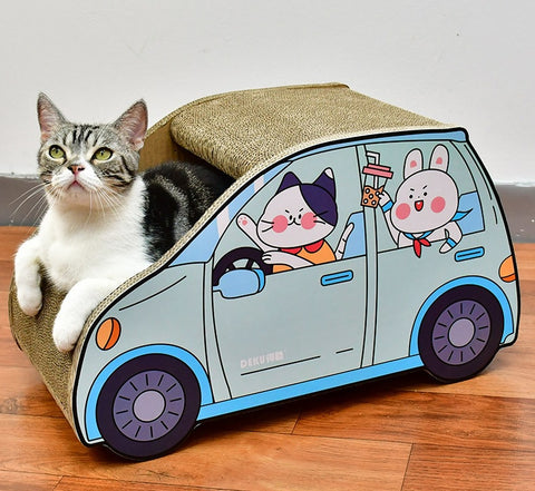 A cat is seated in a SmartSUV™ toy car, occasionally giving a playful scratch.