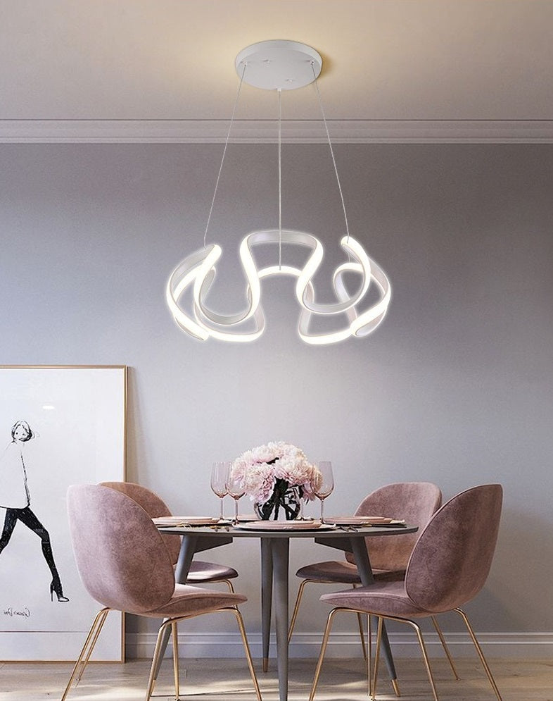 A Nordic dining room with pink chairs and a pendant light chandelier.