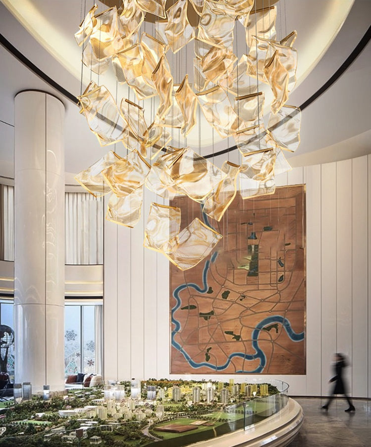The lobby of a hotel with a postmodern chandelier that elevates the space, giving it a touch of glamour.