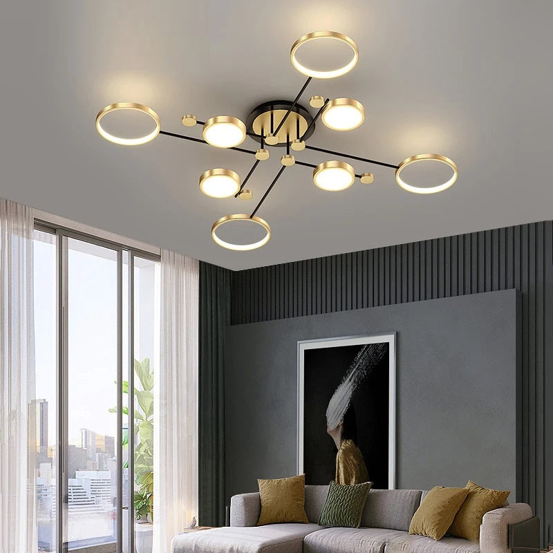 Modern Atomic Starburst Ceiling Light with circular LED lights in a living room with contemporary decor, featuring a large window and neutral tones.