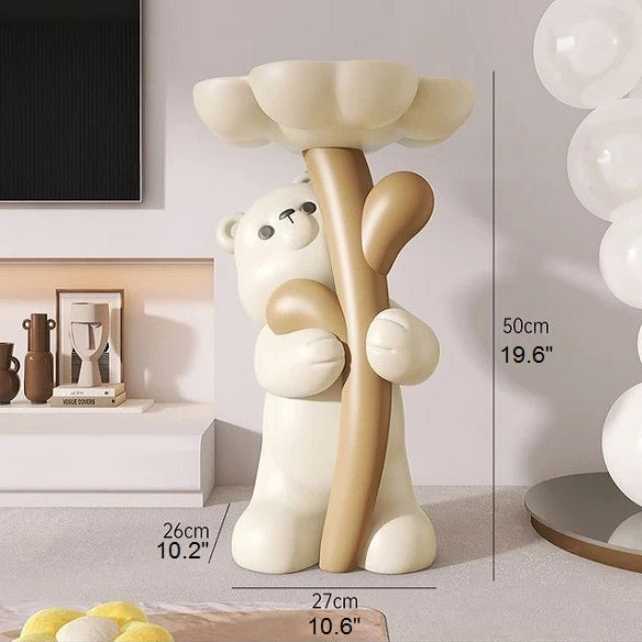 A decorative floor lamp featuring a cartoon-style bear holding a cream-colored column post of the flower table in a modern room. Measurements of the Floral Bear Side Table are displayed.