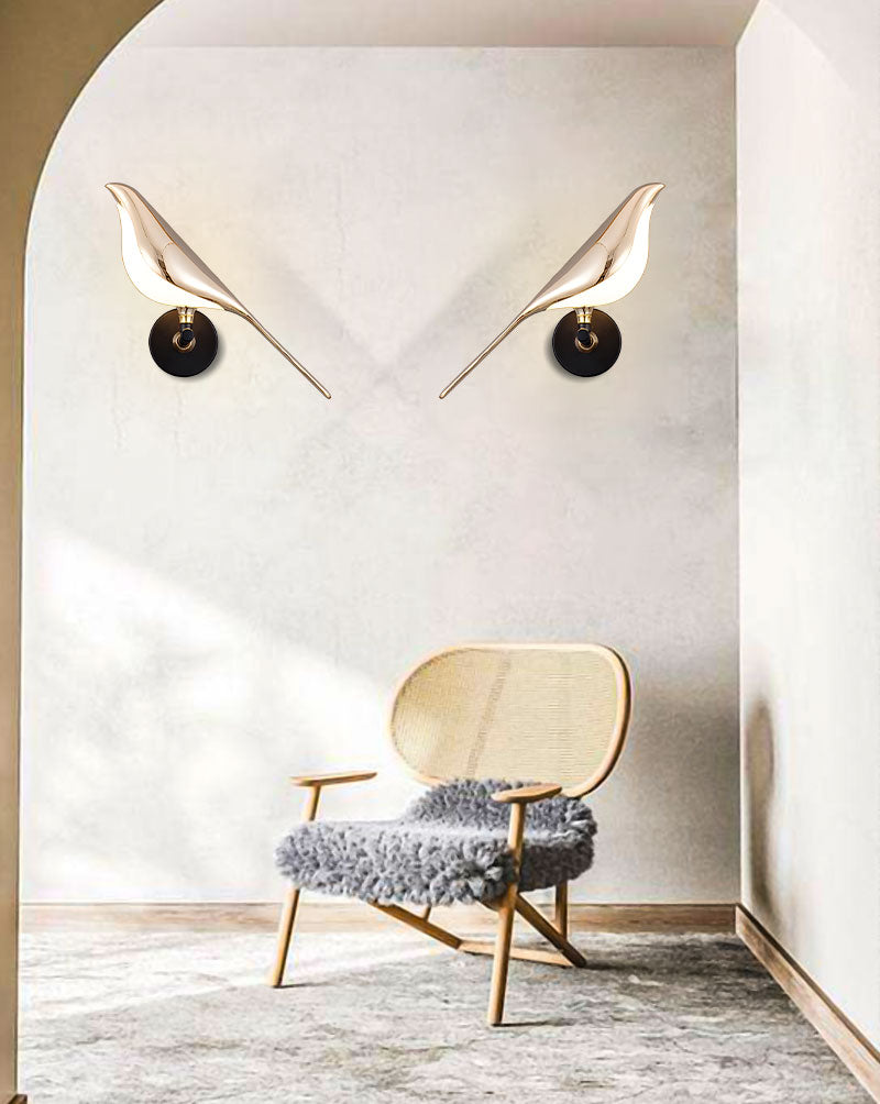 Modern interior design with a chair and accent piece designed to resemble the eyes and beak of a bird wall light.