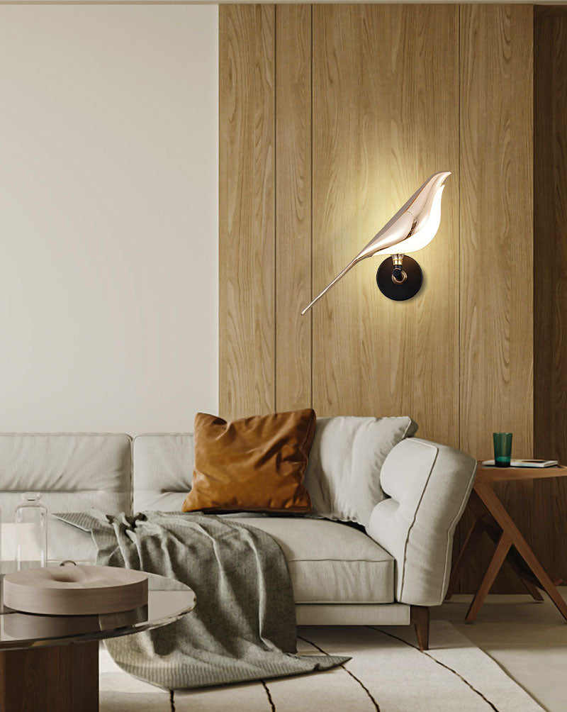 Modern living room with a beige sofa, wooden wall paneling, and a stylish Bird Wall Light as an accent piece.