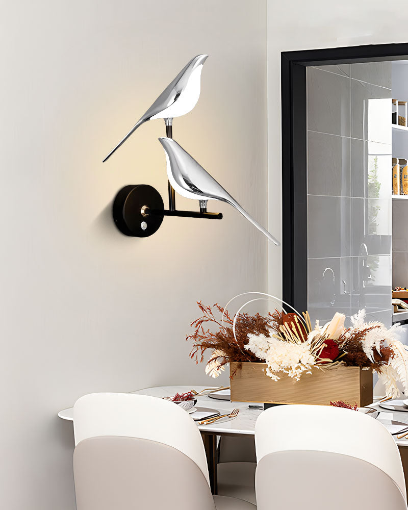 Modern Bird Wall Light sconces illuminate a stylish dining area.